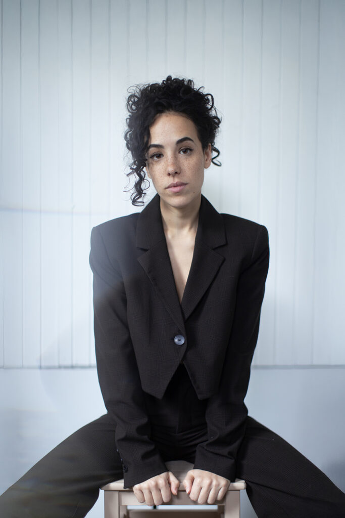 Sarah Charles poses in a black suit